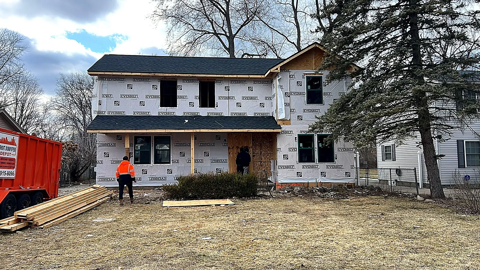Two story home with a new addition house wrapped and crew on site, Livonia MI