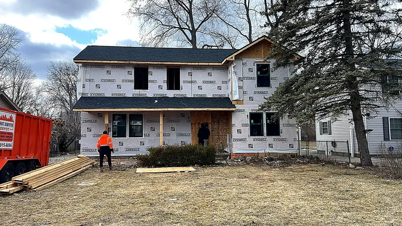 Two story home with a new addition house wrapped and crew on site, Livonia MI