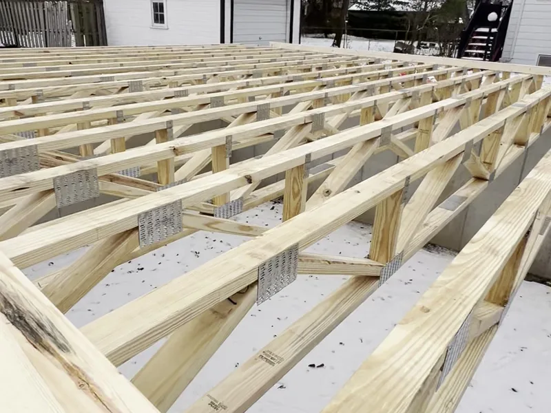Open web floor trusses set on the foundation, winter build, Clawson MI