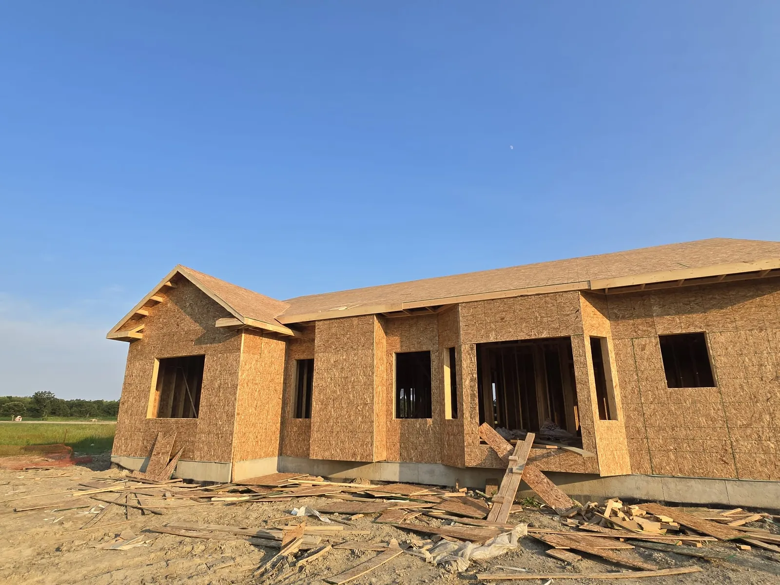 Framed and sheathed ranch home with window openings cut, rough framing labor by Mavericks