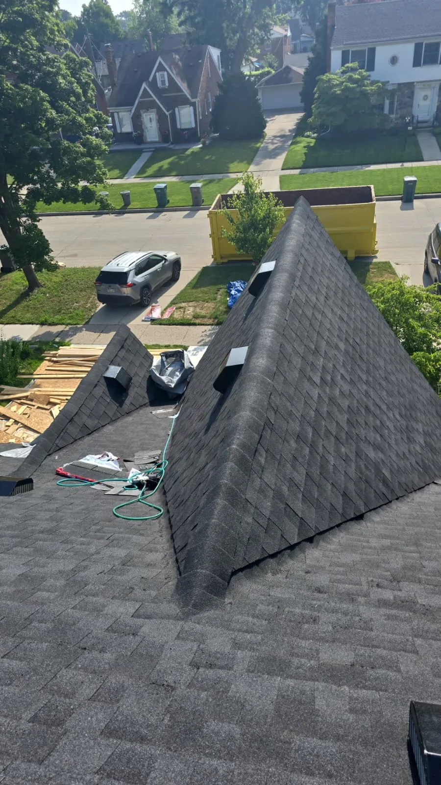 Completed steep-pitch shingle roof on a two-story home