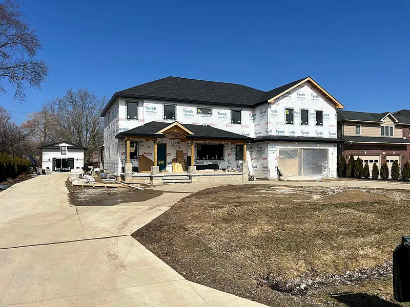 New two story home framed and house wrapped with a covered front porch, Troy MI