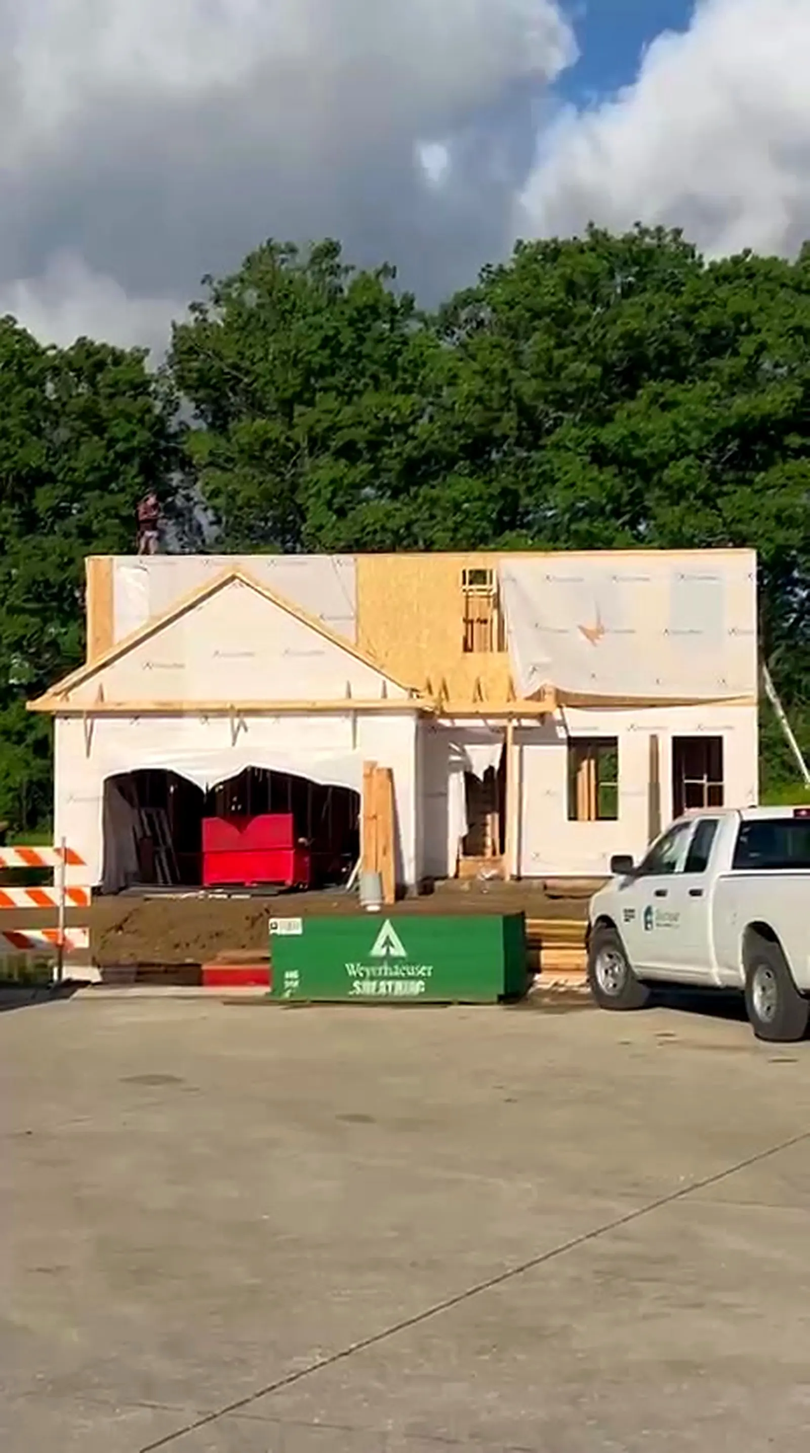 New home framed and house wrapped with the gable and upper floor sheathed, Whitmore Lake MI